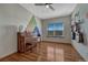 Music room featuring hardwood floors, a piano, guitars, and a large window at 4688 Cedar Glen Pl, Castle Rock, CO 80109
