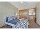 Bedroom with a closet, neutral carpet, and blue bedding in a naturally lit space at 4688 Cedar Glen Pl, Castle Rock, CO 80109