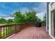 A wooden deck with railing has a covered grill and large window for an outdoor entertaining area at 4688 Cedar Glen Pl, Castle Rock, CO 80109