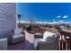 Outdoor deck area with comfortable seating, heater, and scenic neighborhood views at 4688 Cedar Glen Pl, Castle Rock, CO 80109