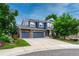 Charming blue two-story home featuring a stone accented three-car garage and a well-manicured lawn at 4688 Cedar Glen Pl, Castle Rock, CO 80109