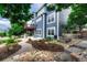 Exterior view of the home featuring a back deck, patio area, and stone walkway through landscaped grounds at 4688 Cedar Glen Pl, Castle Rock, CO 80109