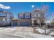 Charming two-story home with a stone-accented facade and a three-car garage at 4688 Cedar Glen Pl, Castle Rock, CO 80109