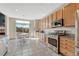 Bright eat-in kitchen features stainless appliances, tile flooring, and a breakfast nook with backyard views at 4688 Cedar Glen Pl, Castle Rock, CO 80109