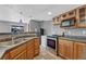 Well-equipped kitchenette featuring stainless steel appliances and classic wooden cabinets at 4688 Cedar Glen Pl, Castle Rock, CO 80109