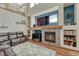 A spacious living room with a fireplace and built-in shelving at 4688 Cedar Glen Pl, Castle Rock, CO 80109