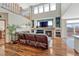 A spacious living room with hardwood floors, a fireplace, and high ceilings at 4688 Cedar Glen Pl, Castle Rock, CO 80109