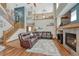 A spacious living room with hardwood floors, a fireplace, and stairs to the second floor at 4688 Cedar Glen Pl, Castle Rock, CO 80109