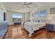 Inviting primary bedroom with a vaulted ceiling, hardwood floors, and large windows at 4688 Cedar Glen Pl, Castle Rock, CO 80109