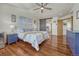 Bright primary bedroom features hardwood floors, a vaulted ceiling, and a sliding barn door at 4688 Cedar Glen Pl, Castle Rock, CO 80109