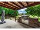 Outdoor kitchen featuring a stainless steel grill and stone surround with a concrete patio under a covered deck at 4688 Cedar Glen Pl, Castle Rock, CO 80109