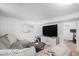 Inviting basement with neutral sectional, flat screen TV, and access to home gym at 10983 W Exposition Pl, Lakewood, CO 80226