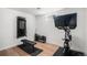 This home features a private gym with a workout machine, bike, bench, and wood flooring at 10983 W Exposition Pl, Lakewood, CO 80226