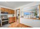 Well-lit kitchen next to dining area, featuring wood cabinetry and modern appliances at 10983 W Exposition Pl, Lakewood, CO 80226