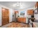 Traditional kitchen featuring wood cabinets, stainless steel appliances, and unique tiled floors at 10983 W Exposition Pl, Lakewood, CO 80226