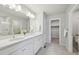 Elegant bathroom features double sinks, modern fixtures, and a walk-in shower at 21091 E 63Rd Dr, Aurora, CO 80019