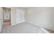 Bright bedroom with neutral walls, carpeted floor, closet and hallway doorway at 21091 E 63Rd Dr, Aurora, CO 80019