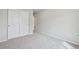 Bedroom featuring neutral walls and carpet, large closet with sliding doors, and electric outlets at 21091 E 63Rd Dr, Aurora, CO 80019