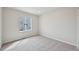 This bedroom has neutral walls and carpet, and one large window at 21091 E 63Rd Dr, Aurora, CO 80019