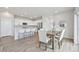 Bright dining area flows into a kitchen with stainless appliances and a breakfast bar at 21091 E 63Rd Dr, Aurora, CO 80019
