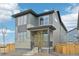 Beautiful gray home featuring modern architecture and well-maintained landscaping at 21091 E 63Rd Dr, Aurora, CO 80019