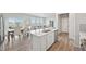 Open concept kitchen with bar stool seating that faces a dining and living area at 21091 E 63Rd Dr, Aurora, CO 80019