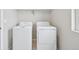 This is a laundry room featuring a newer model, white, side-by-side washer and dryer set at 21091 E 63Rd Dr, Aurora, CO 80019
