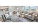 Open-concept layout seamlessly connects living and dining spaces, filled with natural light at 21091 E 63Rd Dr, Aurora, CO 80019