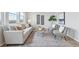 Bright living room featuring neutral tones, stylish furniture, and large windows at 21091 E 63Rd Dr, Aurora, CO 80019