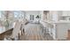 Open-concept living space with bright windows, sleek flooring, and modern kitchen island with bar seating at 21091 E 63Rd Dr, Aurora, CO 80019