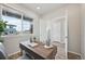 Stylish home office with a view features a modern desk and sleek wood flooring at 21091 E 63Rd Dr, Aurora, CO 80019