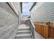 Side yard features a gray concrete walkway and stone wall; new wooden fence on neighbor's side at 21091 E 63Rd Dr, Aurora, CO 80019