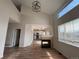 Open living room featuring a fireplace, hardwood floors, and large windows providing ample natural light at 5241 S Shawnee St, Aurora, CO 80015