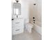 Modern bathroom featuring a bathtub, a shower, white tile walls and a white vanity at 3022 Fenton St, Wheat Ridge, CO 80214