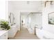 Bright bathroom featuring double vanities, standalone tub, and glass enclosed shower for a luxurious experience at 3022 Fenton St, Wheat Ridge, CO 80214