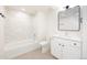 A bathroom featuring neutral tiled walls, white vanity and updated fixtures at 3022 Fenton St, Wheat Ridge, CO 80214