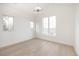 A bright bedroom with large windows offers great views and beautiful wood floors at 3022 Fenton St, Wheat Ridge, CO 80214