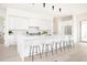 Bright kitchen featuring a large center island with barstool seating and contemporary finishes at 3022 Fenton St, Wheat Ridge, CO 80214