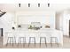 Bright white kitchen features a large island with seating and modern appliances for a clean, contemporary look at 3022 Fenton St, Wheat Ridge, CO 80214