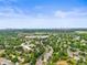 Expansive aerial view of a suburban neighborhood with lush greenery and a distant skyline on a sunny day at 6811 S Clermont Dr, Centennial, CO 80122