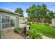 Landscaped backyard featuring green lawn, patio area, detached garage, and well-maintained garden at 6811 S Clermont Dr, Centennial, CO 80122