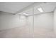 Spacious unfinished basement with neutral carpet and bright overhead lighting at 6811 S Clermont Dr, Centennial, CO 80122