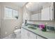 Bathroom featuring modern sink, countertop, and medicine cabinet over the sink at 6811 S Clermont Dr, Centennial, CO 80122