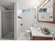 This is a small bathroom with linoleum floors and a glass shower door at 6811 S Clermont Dr, Centennial, CO 80122
