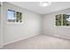 This bedroom is newly painted, has carpet, and has two windows at 6811 S Clermont Dr, Centennial, CO 80122