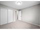 Bedroom with ample closet space, neutral paint, and carpeted floors at 6811 S Clermont Dr, Centennial, CO 80122