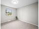 Cozy bedroom with neutral paint, carpeted floors, and a view from a well-lit window at 6811 S Clermont Dr, Centennial, CO 80122