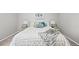 Close up of a well decorated bedroom with a soft white comforter at 6811 S Clermont Dr, Centennial, CO 80122