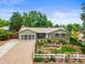 Charming single-story home featuring a well-manicured front yard and a brick facade at 6811 S Clermont Dr, Centennial, CO 80122