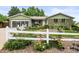 This home boasts lovely curb appeal with a well-maintained lawn and inviting white picket fence at 6811 S Clermont Dr, Centennial, CO 80122
